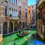 Narrow canal with Gondola in Venice