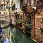 Narrow canal with Gondola in Venice